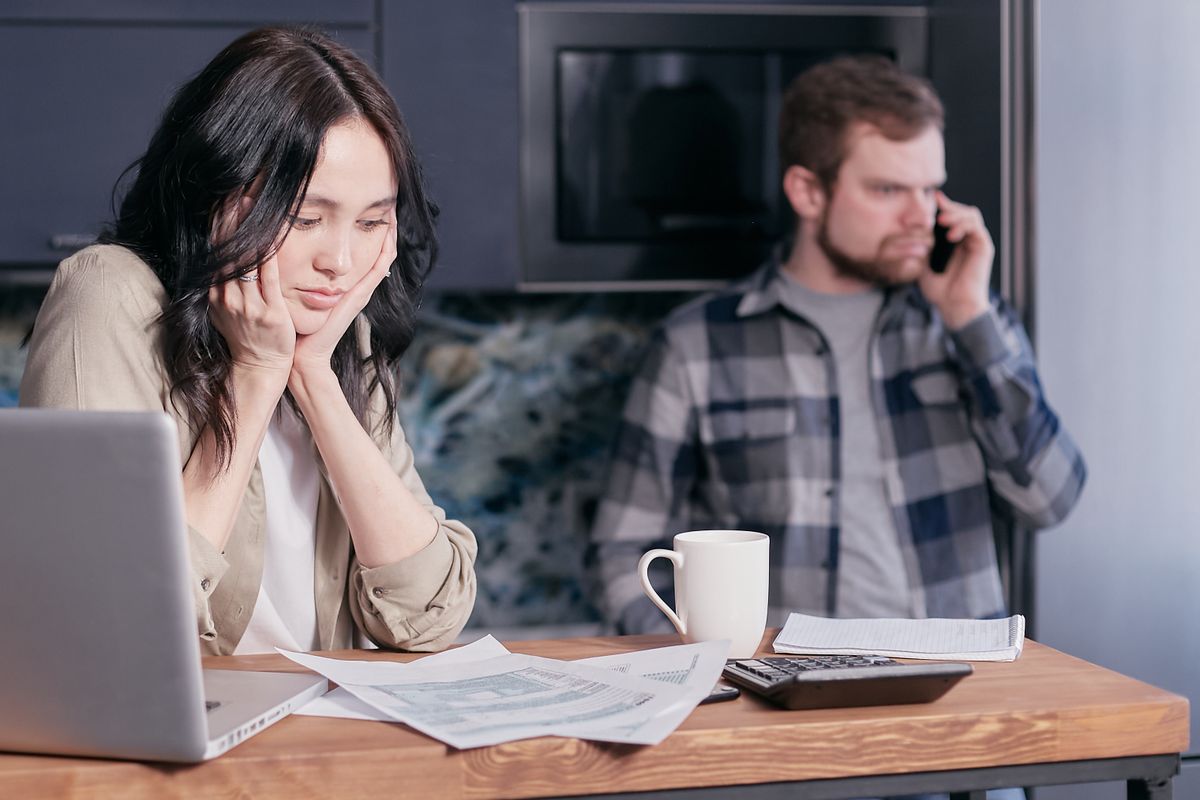 Two colleagues going through work on a laptop