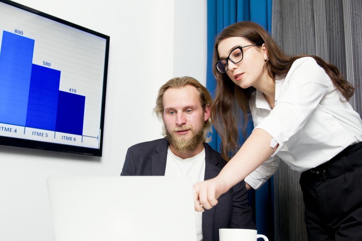 A pair reviewing records on screen